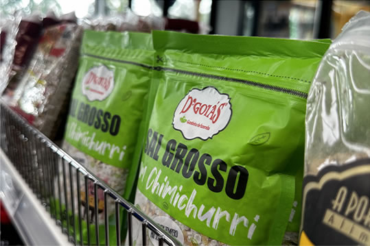 Bags of coarse salt with chimichurri on a shelf at Brazmarket